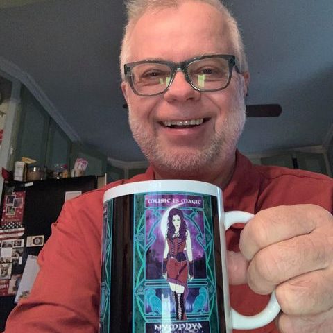 Man holding the black Music is Magic mug